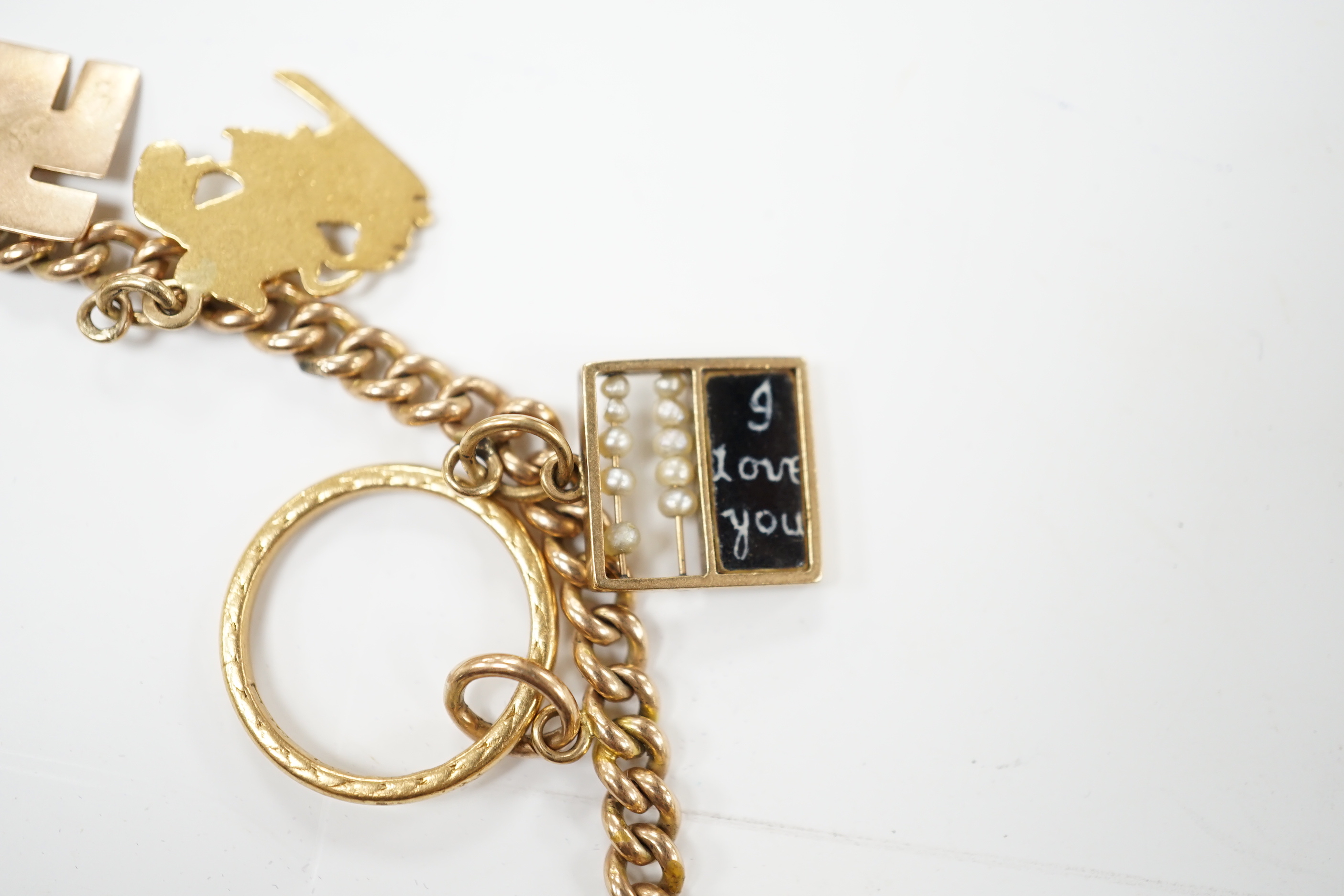 A 9ct gold curblink chain hung with fifteen assorted charms including a 1906 sovereign and an 1865 20 francs coin, gross 80.8 grams